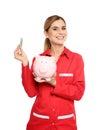 Portrait of female emergency doctor with piggy bank and money Royalty Free Stock Photo