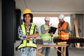 Portrait of female engineer holding walkie talkie and male engineer with working together inspection housing estate Royalty Free Stock Photo