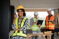 Portrait of female engineer holding walkie talkie and male engineer with working together inspection housing estate Royalty Free Stock Photo