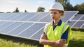 Portrait Of Female Engineer Inspecting Solar Panels In Field Generating Renewable Energy