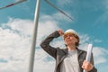 Portrait of female engineer on modern wind turbine farm