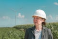 Portrait of female engineer on modern wind turbine farm