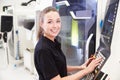 Portrait Of Female Engineer Operating CNC Machinery