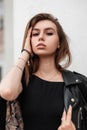 Portrait of a female face with beautiful natural makeup with sexy lips. Attractive pretty sensual girl model in stylish black