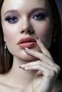 Portrait of female face. Hand with black french manicure nailsnear face Royalty Free Stock Photo