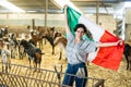 Portrait of female farmer with Mexican flag in their hands in goat pen at farm Royalty Free Stock Photo