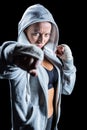 Portrait of female fighter in hood with fighting stance Royalty Free Stock Photo