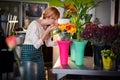 Portrait of female florist smelling rose flowers Royalty Free Stock Photo