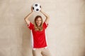 Female football fan holding soccer ball while cheering for her team at world championship Royalty Free Stock Photo