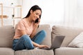 Woman talking on mobile phone sitting on sofa Royalty Free Stock Photo