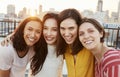 Portrait Of Female Friends Gathered On Rooftop Terrace For Party With City Skyline In Background Royalty Free Stock Photo