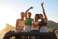 Portrait Of Female Friends Standing Up Through Sun Roof Car And Dancing On Road Trip Royalty Free Stock Photo
