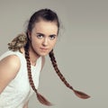 Portrait of female girl with pigtails hairstyle and baby owl on the shoulder