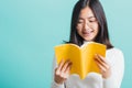 Portrait female in glasses is holding and reading a book Royalty Free Stock Photo