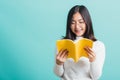Portrait female in glasses is holding and reading a book Royalty Free Stock Photo