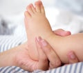 Portrait of female hand holding baby foot Royalty Free Stock Photo