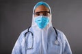 Portrait of female health worker wearing protective clothes against grey background Royalty Free Stock Photo