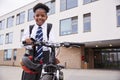 Portrait Of Female High School Student Wearing Uniform With Bicycle Outside School Buildings Royalty Free Stock Photo