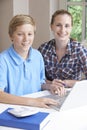 Portrait Of Female Home Tutor Helping Boy With Studies Using Lap Royalty Free Stock Photo