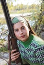 Portrait of a female hunter with a gun