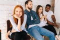 Portrait of female job candidates smiling looking at camera while waiting interview sitting in queue line row with Royalty Free Stock Photo