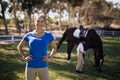 Portrait of female jockey with sister by horse in background Royalty Free Stock Photo