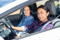 Portrait of female latino american driver and her friend