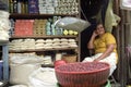 Portrait of female Latino grocer in doorway of store