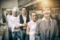 Portrait of female manager posing with staff