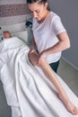 Massage therapist doing lymphatic drainage treatment to woman Royalty Free Stock Photo