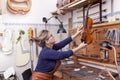 Portrait of female mature violin maker Royalty Free Stock Photo