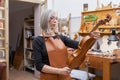 Portrait of female mature violin maker Royalty Free Stock Photo