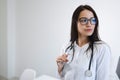 Portrait of female medic with stethoscope. Beautiful young nurse with glasses.