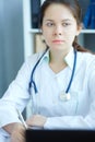 Portrait of female medicine doctor hand holding silver pen writing something on clipboard closeup. Ward round, patient Royalty Free Stock Photo