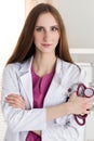 Portrait of female medicine therapeutist doctor standing with ha