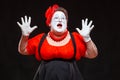 Portrait of female mime artist, isolated on black background. Racy woman throwing up her hands and shouting. Symbol of Royalty Free Stock Photo