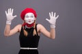 Portrait of female mime with red hat and white