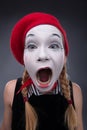 Portrait of female mime in red head and with white Royalty Free Stock Photo