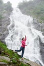 Portrait of female model against waterfall Balea in Fagarash mountains Royalty Free Stock Photo