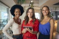 Portrait Of Female Multi-Cultural Business Team With Digital Tablet In Busy Office Royalty Free Stock Photo