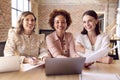 Portrait Of Female Multi-Cultural Business Team Meeting Around Laptop In Office Royalty Free Stock Photo