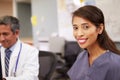 Portrait Of Female Nurse Working At Nurses Station Royalty Free Stock Photo