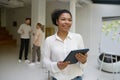 Portrait of female office worker holding digital tablet in hand Royalty Free Stock Photo