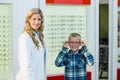 Portrait of female optometrist and young patient Royalty Free Stock Photo