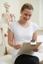 Portrait Of Female Osteopath In Consulting Room Royalty Free Stock Photo