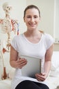 Portrait Of Female Osteopath In Consulting Room With Digital Tab Royalty Free Stock Photo