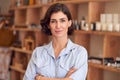 Portrait Of Female Owner Of Gift Store Standing In Front Of Shelves With Cosmetics And Candles Royalty Free Stock Photo