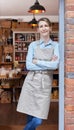 Portrait Of Female Owner Standing In Doorway Of Delicatessen  Food Shop Royalty Free Stock Photo