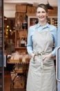 Portrait Of Female Owner Standing In Doorway Of Delicatessen  Food Shop Royalty Free Stock Photo