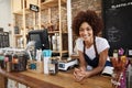 Portrait Of Female Owner Of Sustainable Plastic Free Grocery Store Behind Sales Desk